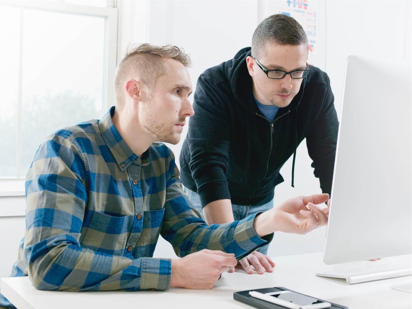 Photo of Kevin and Jon working at a desk